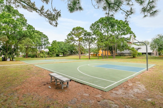 view of sport court featuring a yard