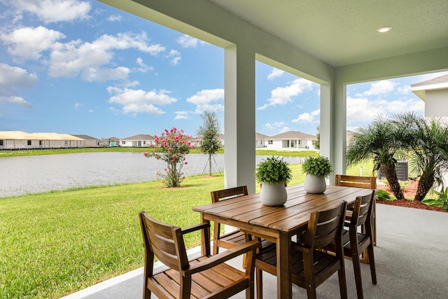 view of patio with a water view