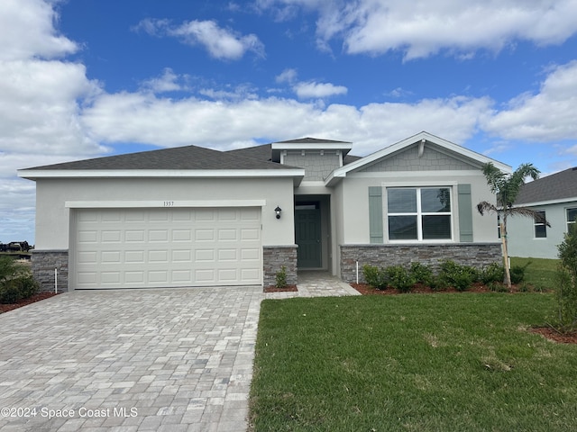 view of front facade featuring a front lawn and a garage