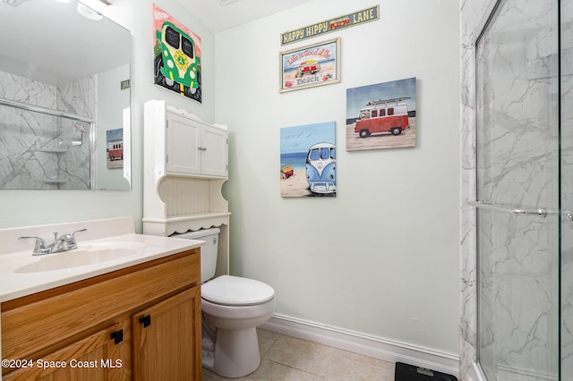 bathroom with tile patterned flooring, vanity, an enclosed shower, and toilet