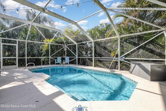 view of pool with a lanai and a patio