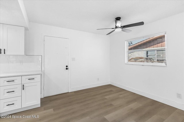 empty room with hardwood / wood-style flooring and ceiling fan