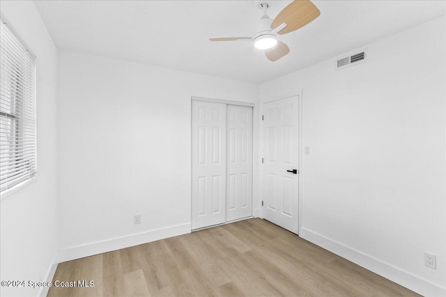 unfurnished bedroom featuring ceiling fan, a closet, and light hardwood / wood-style floors