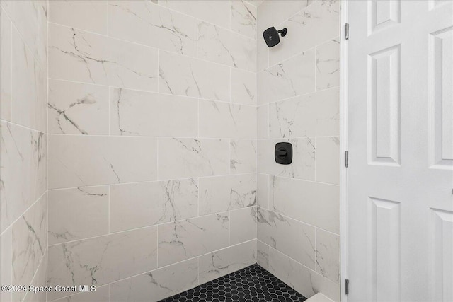 bathroom with a tile shower