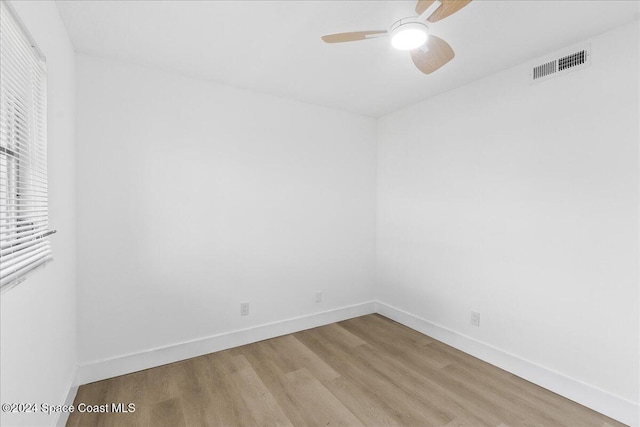 spare room with ceiling fan and light wood-type flooring