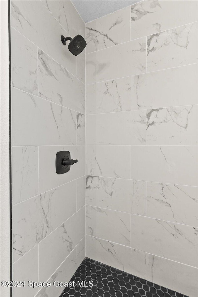 bathroom with a tile shower