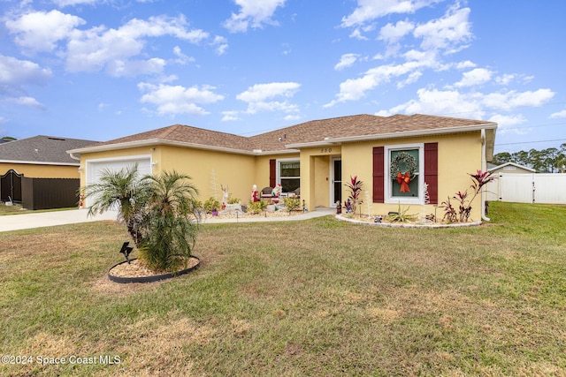 view of front of house with a front yard and a garage