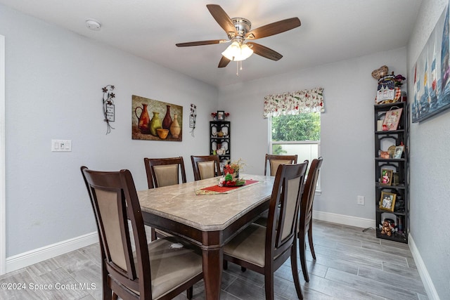 dining room with hardwood / wood-style floors and ceiling fan