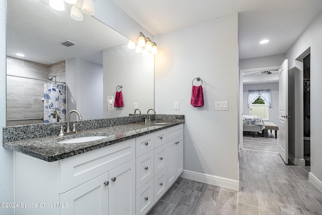 bathroom featuring a shower with shower curtain, vanity, and hardwood / wood-style flooring