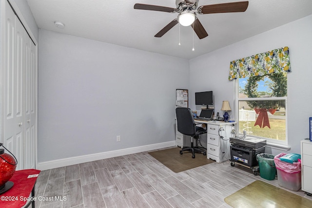 home office featuring ceiling fan and light hardwood / wood-style floors