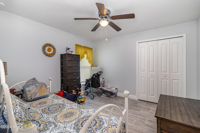 bedroom featuring light hardwood / wood-style flooring, a closet, and ceiling fan