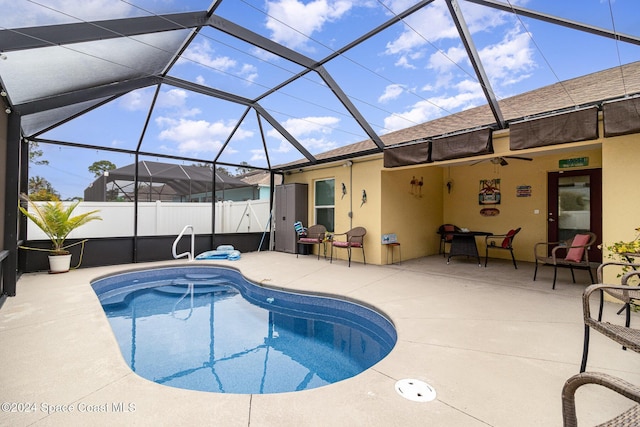 view of swimming pool featuring a patio and glass enclosure