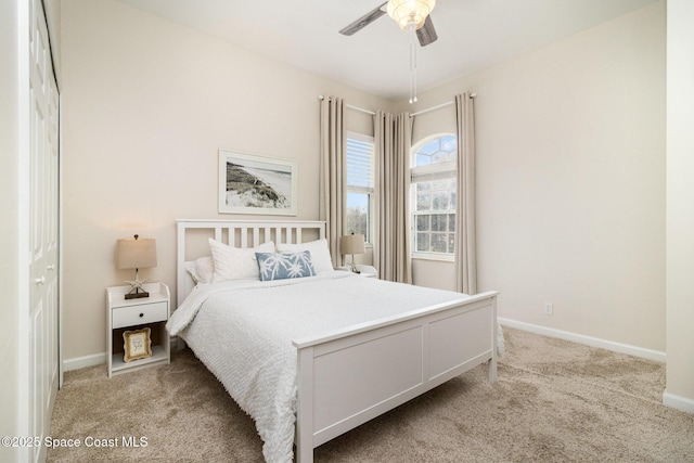 carpeted bedroom with a closet and ceiling fan