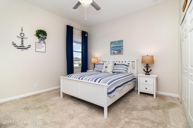 carpeted bedroom featuring a closet and ceiling fan