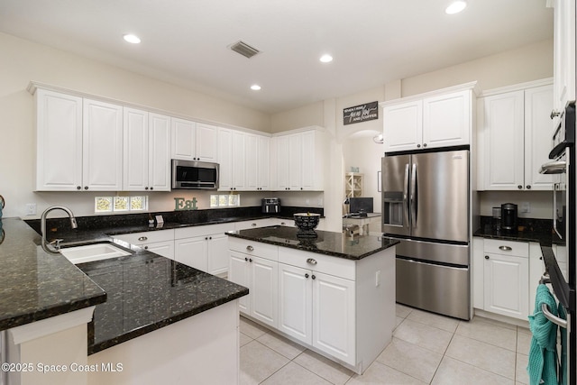 kitchen with sink, white cabinets, and appliances with stainless steel finishes