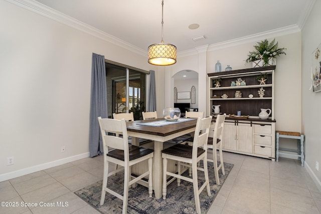 dining area featuring light tile patterned floors and ornamental molding