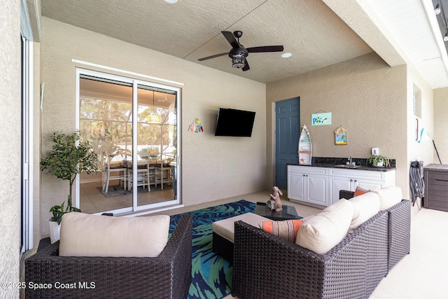 view of patio with sink, an outdoor hangout area, and ceiling fan