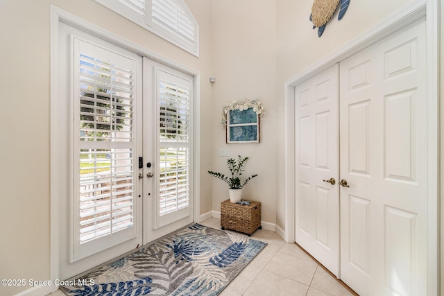 doorway featuring light tile patterned floors and french doors