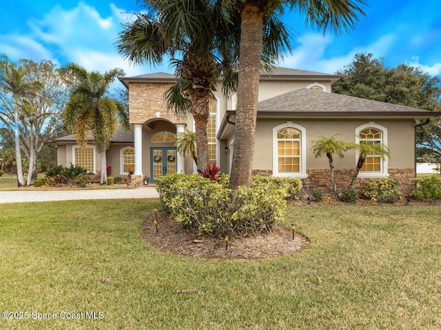 mediterranean / spanish home featuring a front lawn