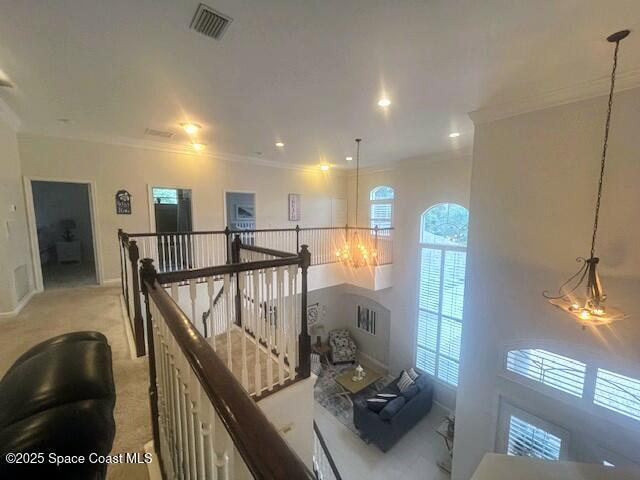 hallway featuring light colored carpet and ornamental molding