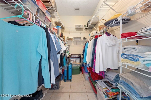 spacious closet with light tile patterned flooring