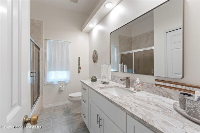 full bathroom with vanity, tile patterned flooring, combined bath / shower with glass door, and toilet