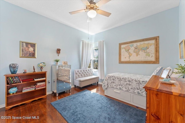 bedroom with lofted ceiling, dark wood-type flooring, a textured ceiling, and ceiling fan