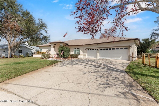 ranch-style house with a garage and a front lawn