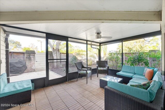 sunroom / solarium featuring ceiling fan