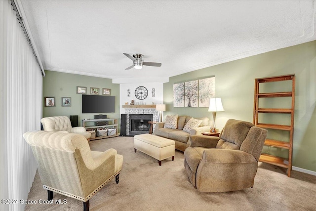 living room featuring a textured ceiling, ceiling fan, light colored carpet, and a fireplace