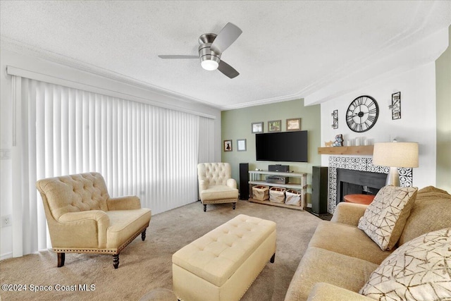 carpeted living room featuring a fireplace, a textured ceiling, and ceiling fan