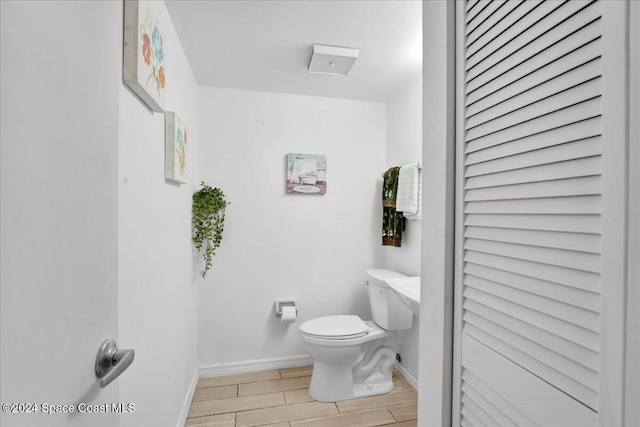 bathroom featuring hardwood / wood-style floors and toilet