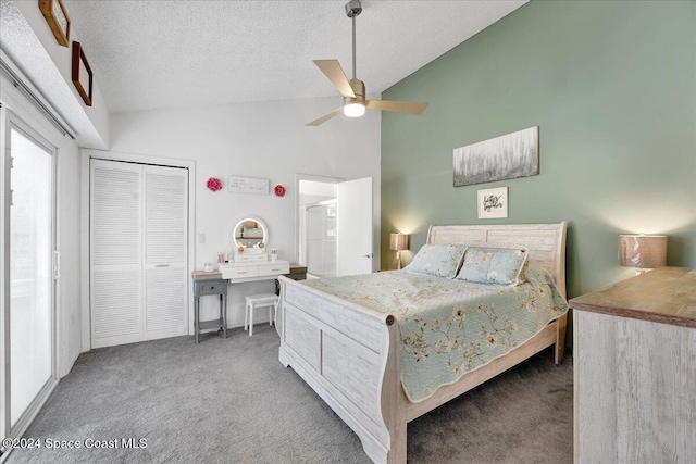 carpeted bedroom featuring a textured ceiling, a closet, high vaulted ceiling, and ceiling fan