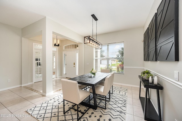 tiled dining space featuring a chandelier