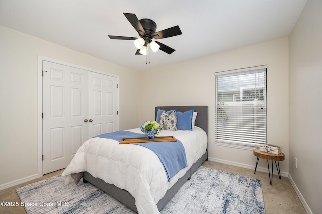 carpeted bedroom featuring ceiling fan and a closet