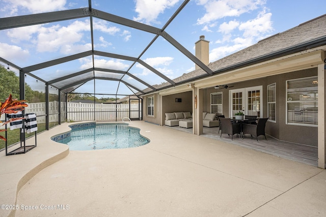 view of pool featuring an outdoor hangout area, ceiling fan, glass enclosure, and a patio