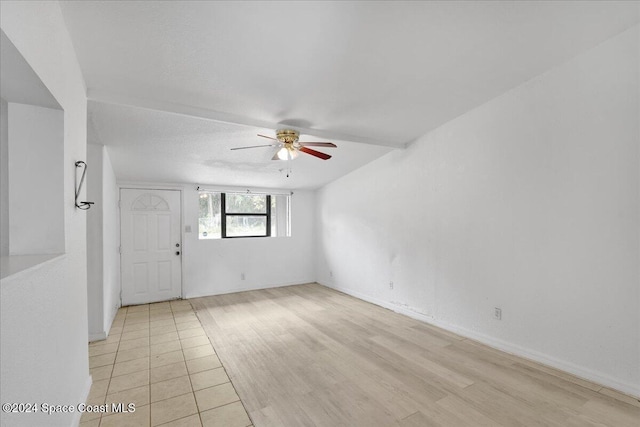 unfurnished room with ceiling fan, light wood-type flooring, and a textured ceiling