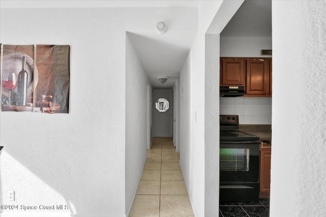 corridor featuring light tile patterned floors