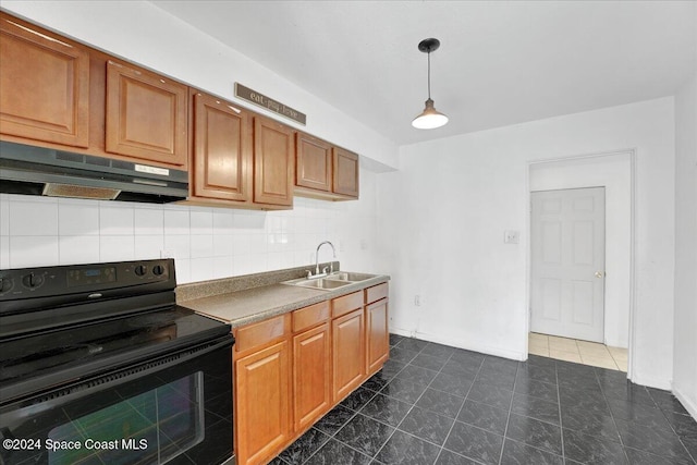 kitchen featuring black range with electric stovetop, sink, hanging light fixtures, tasteful backsplash, and dark tile patterned flooring