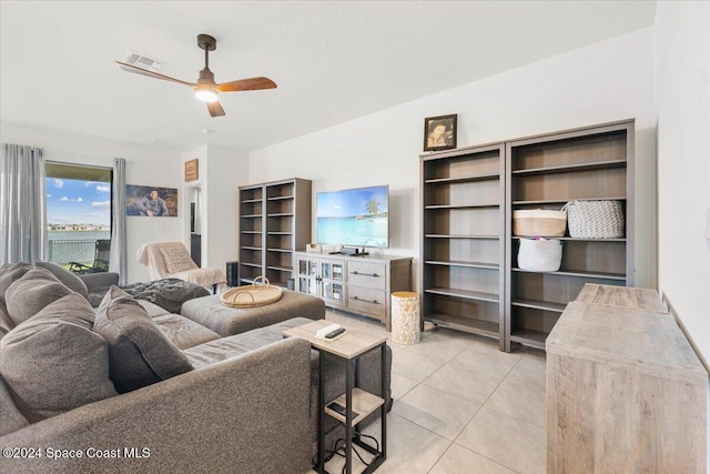 living room with ceiling fan and light tile patterned floors