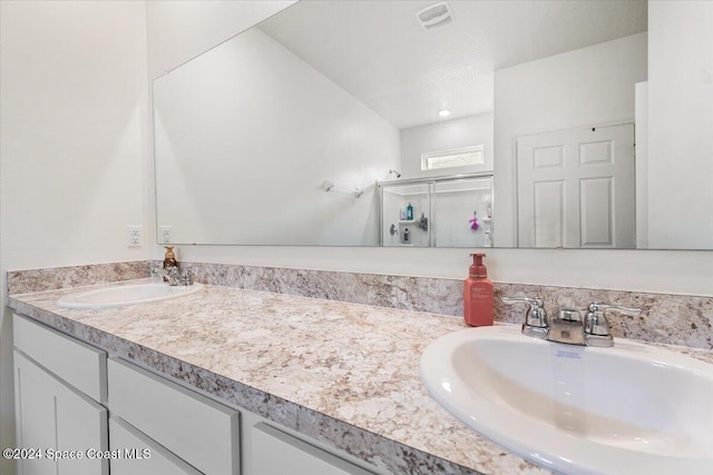 bathroom featuring an enclosed shower and vanity