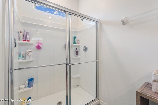 bathroom with a shower with shower door