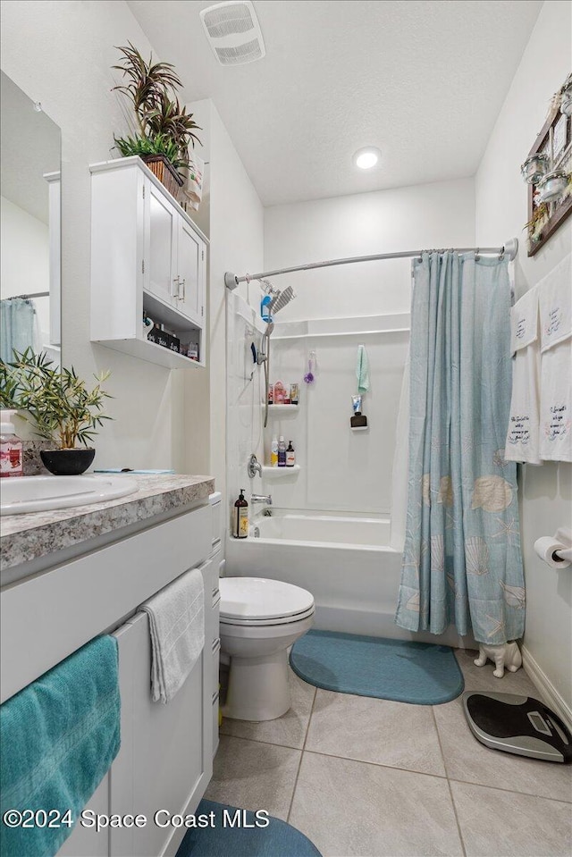 full bathroom with shower / bath combo with shower curtain, toilet, tile patterned flooring, and vanity