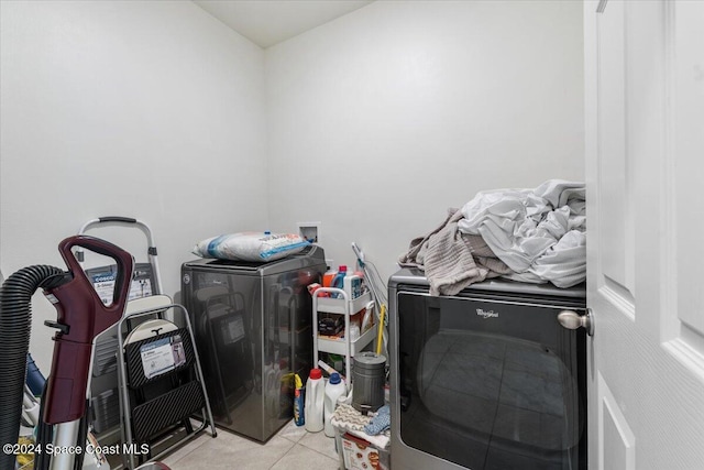 laundry room featuring separate washer and dryer and light tile patterned floors