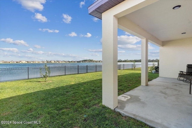 view of yard with a patio area and a water view