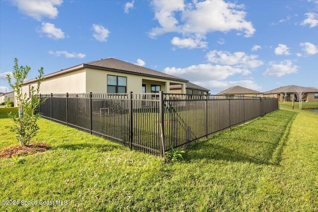 rear view of property with a lawn