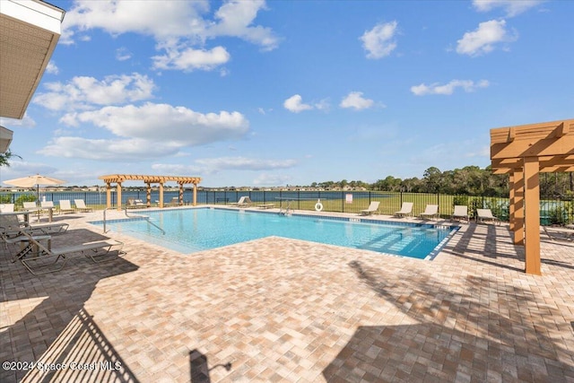 view of swimming pool featuring a patio area and a pergola