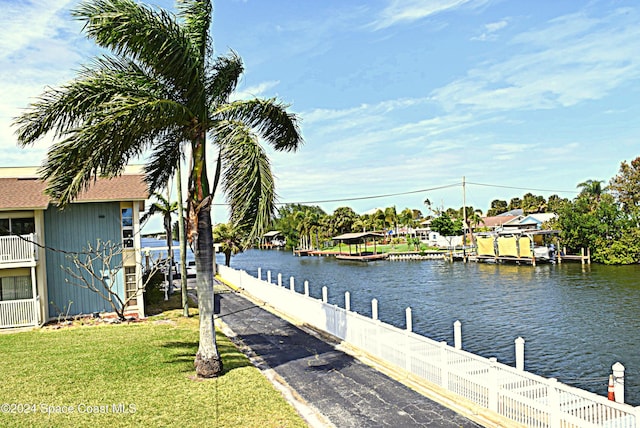 dock area featuring a water view and a yard