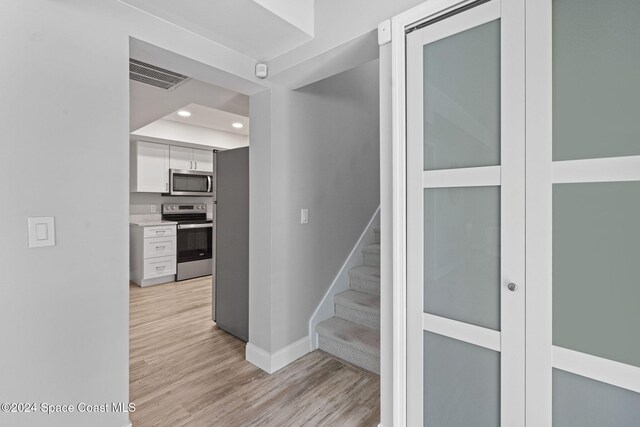 stairs with hardwood / wood-style flooring