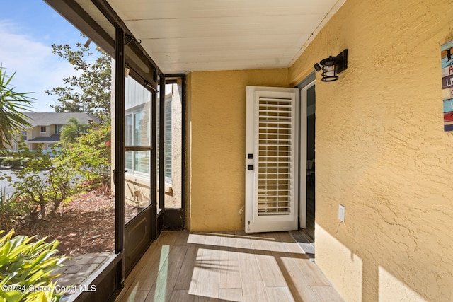 unfurnished sunroom with wood ceiling